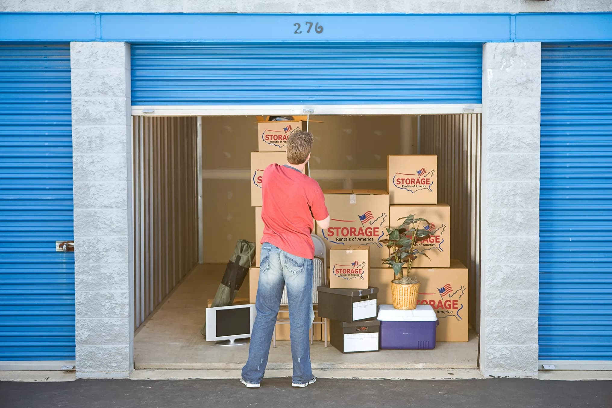 Image of a man standing inside a storage unit